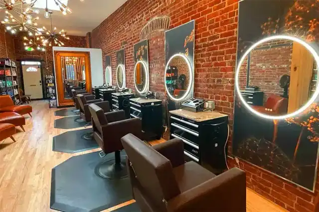 Barbering student giving a classic clipper cut in the training studio